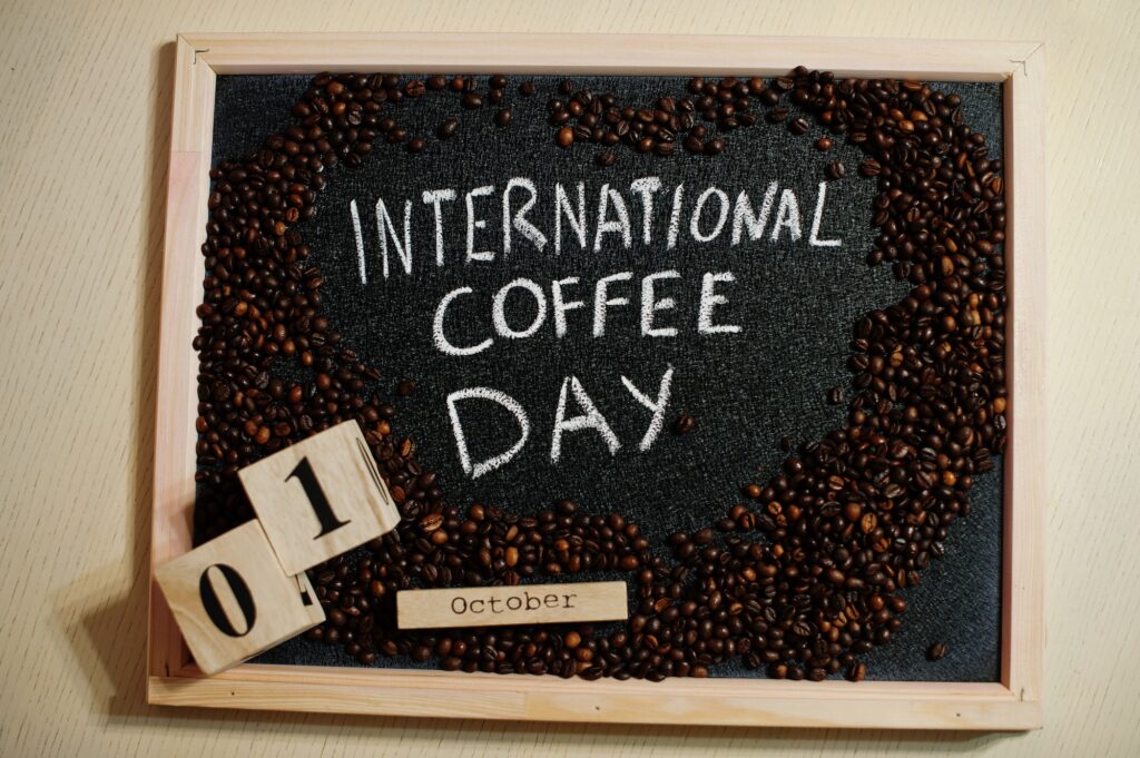 International coffe day words on blackboard flat lay.